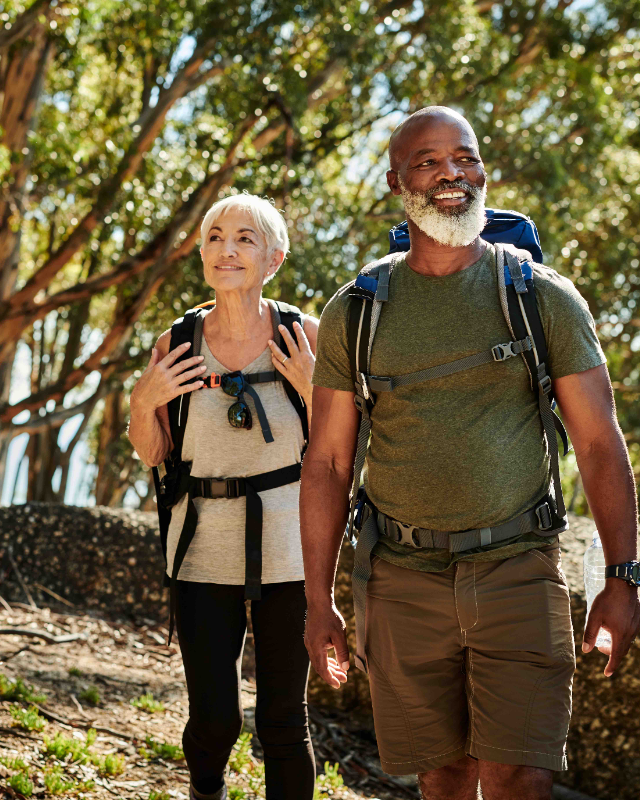 Retired couple hiking in the woods